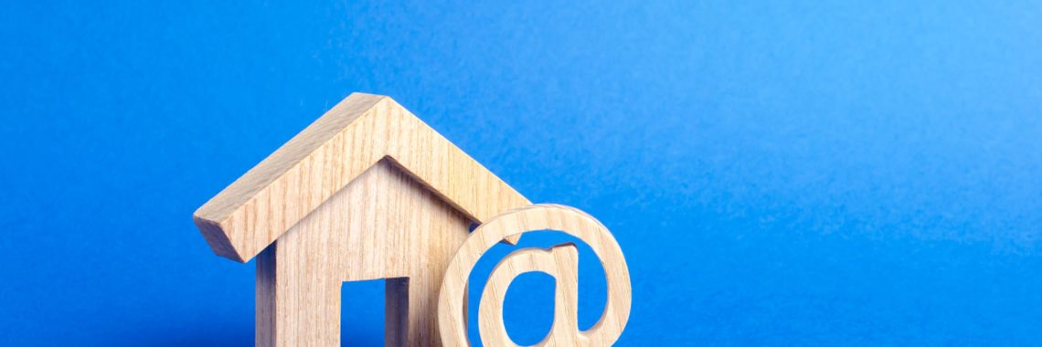 wooden block of a home with an @ sign representing online home